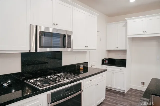 a kitchen with granite countertop cabinets and steel stainless steel appliances