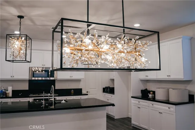 a kitchen with stainless steel appliances granite countertop a sink and a stove