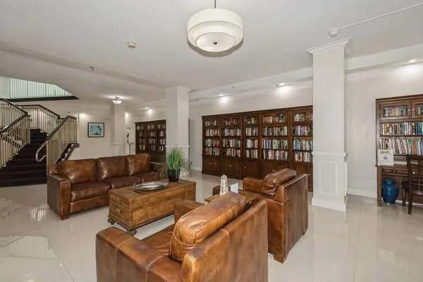 a living room with furniture a air conditioner and a window
