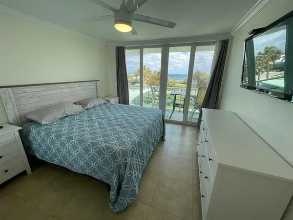 a bed sitting in a bedroom next to a large window