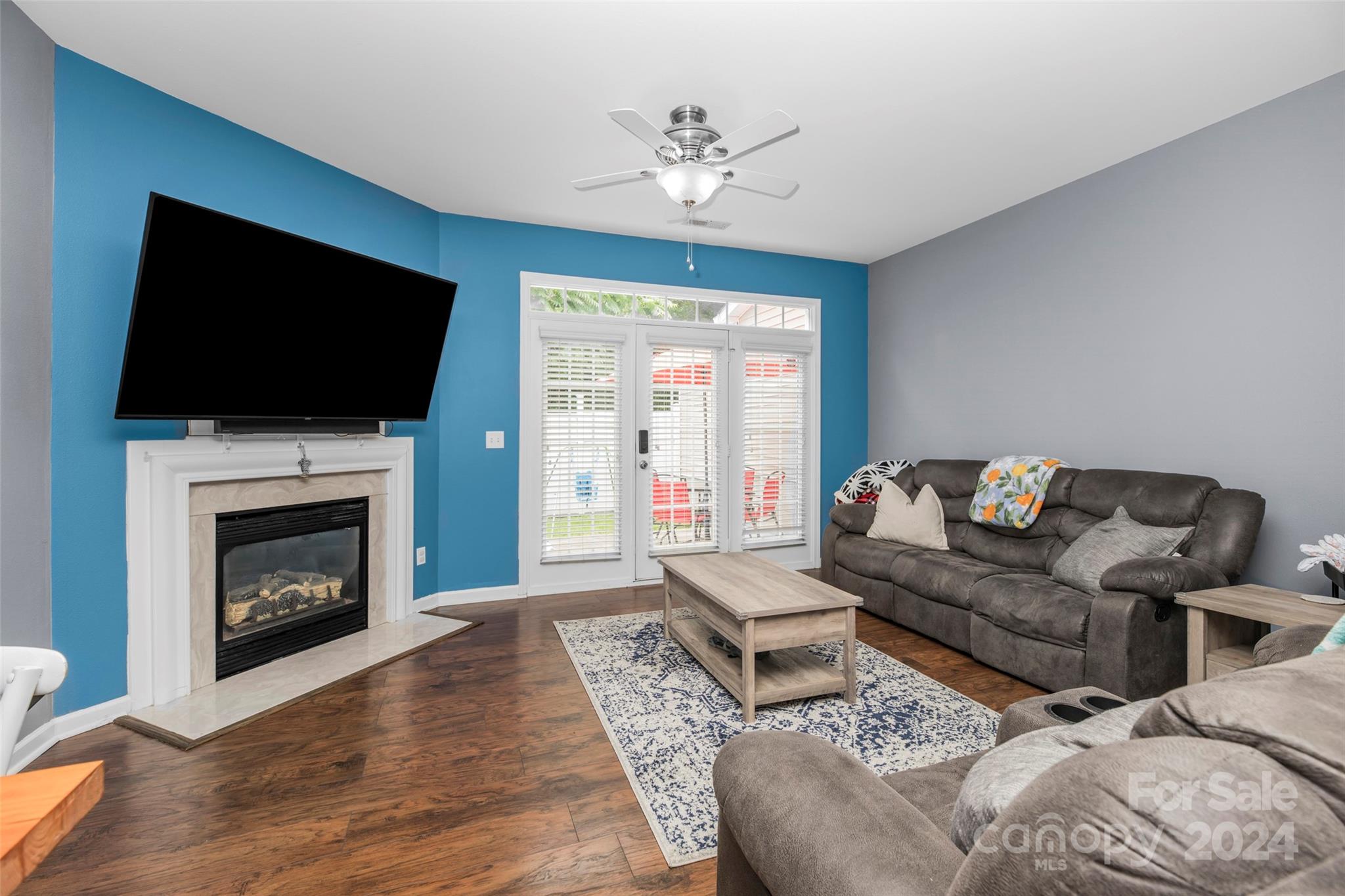 5810 Fox Ridge Lane Winston-Salem, NC 27104 - Photo 11 of 30 a living room with furniture a flat screen tv and a fireplace