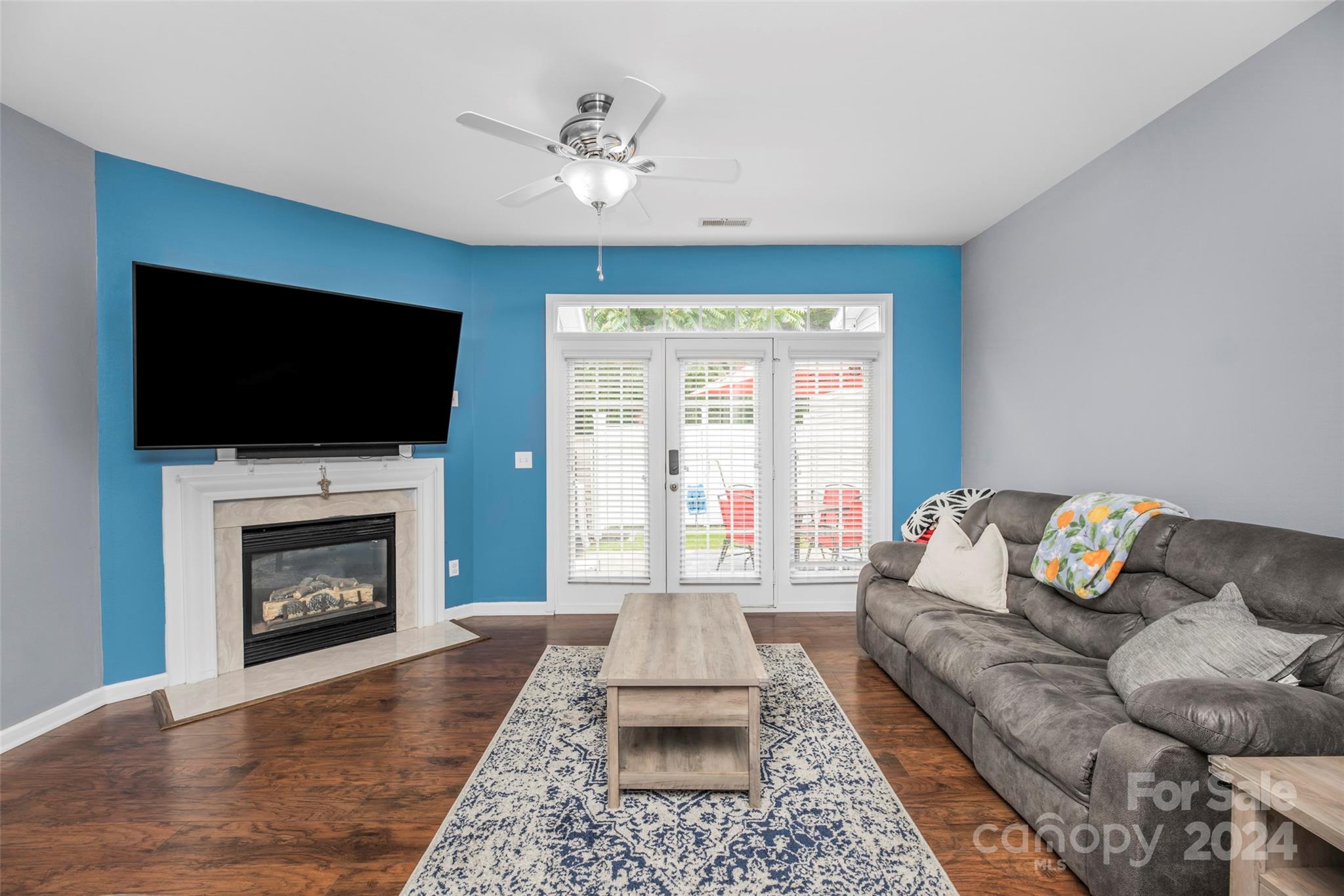 5810 Fox Ridge Lane Winston-Salem, NC 27104 - Photo 12 of 30 a living room with furniture a flat screen tv and a fireplace