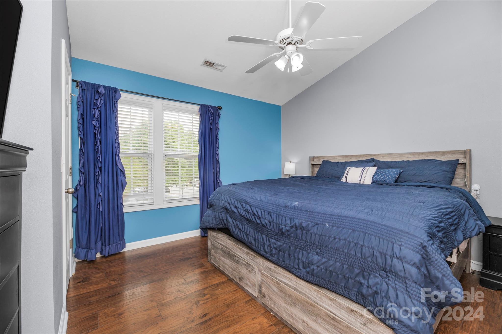 5810 Fox Ridge Lane Winston-Salem, NC 27104 - Photo 17 of 30 a bedroom with a large bed and a chandelier