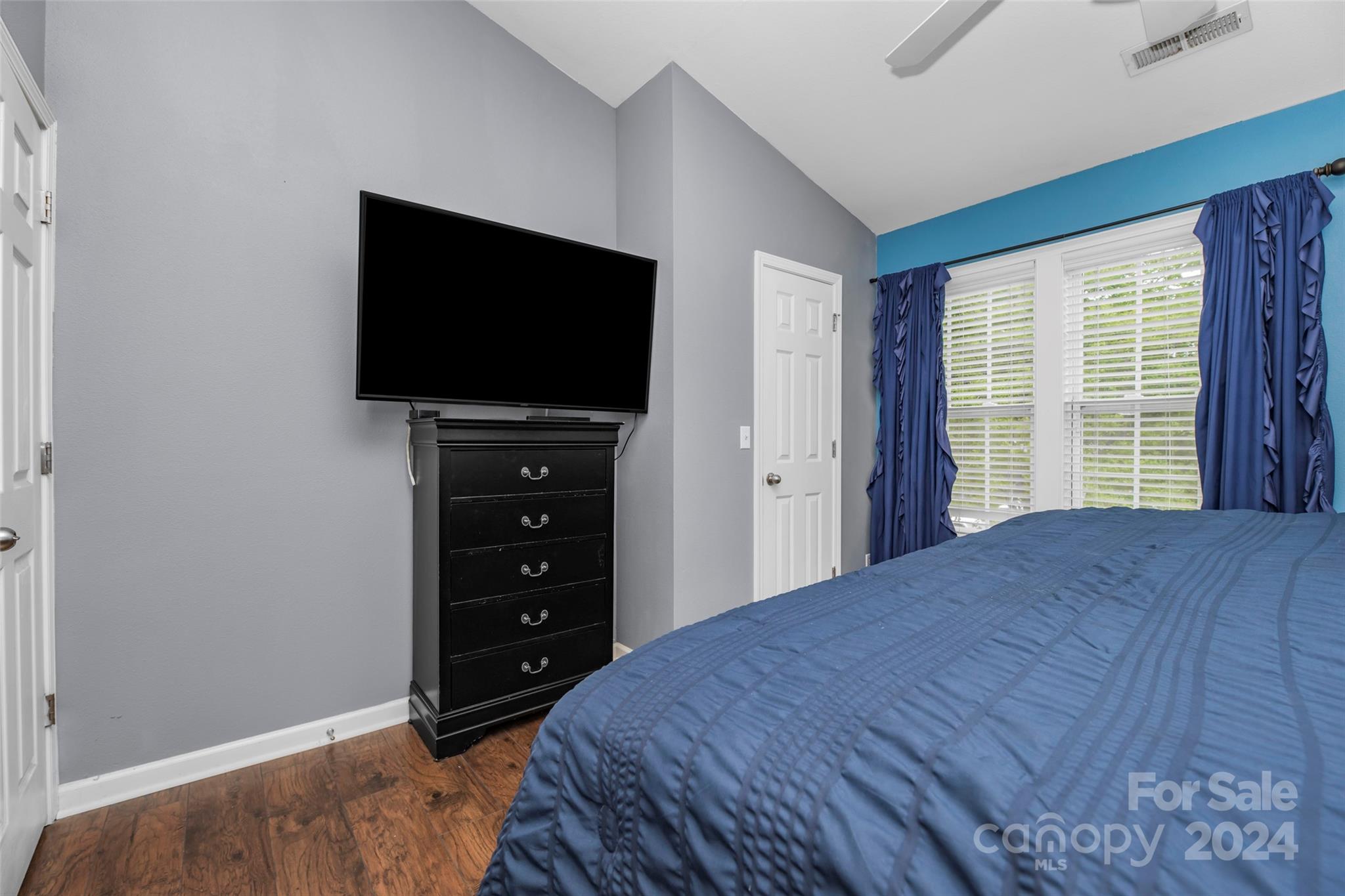5810 Fox Ridge Lane Winston-Salem, NC 27104 - Photo 18 of 30 a bedroom with a bed and a flat screen tv