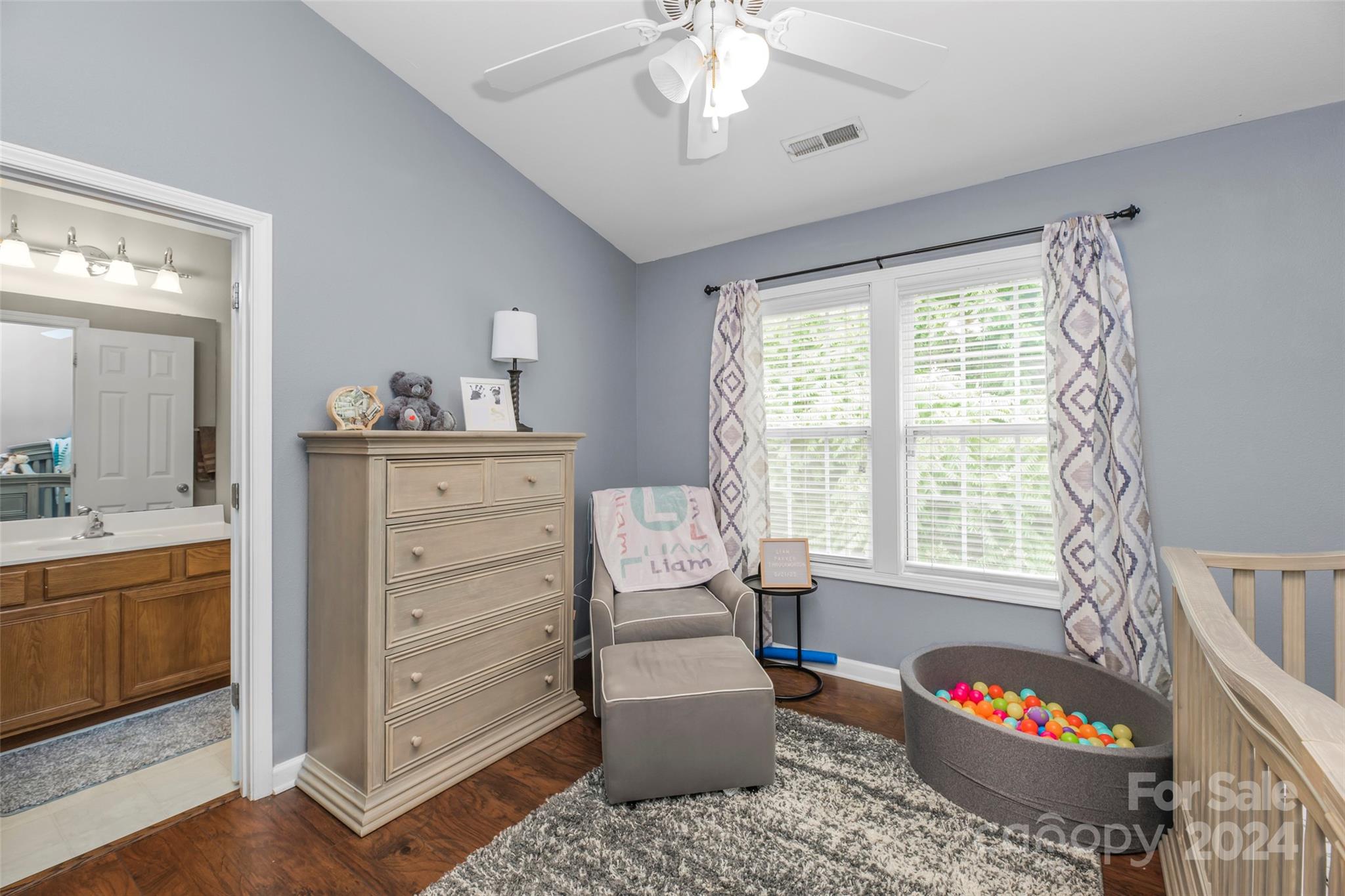 5810 Fox Ridge Lane Winston-Salem, NC 27104 - Photo 23 of 30 a bedroom with a bed and a chandelier