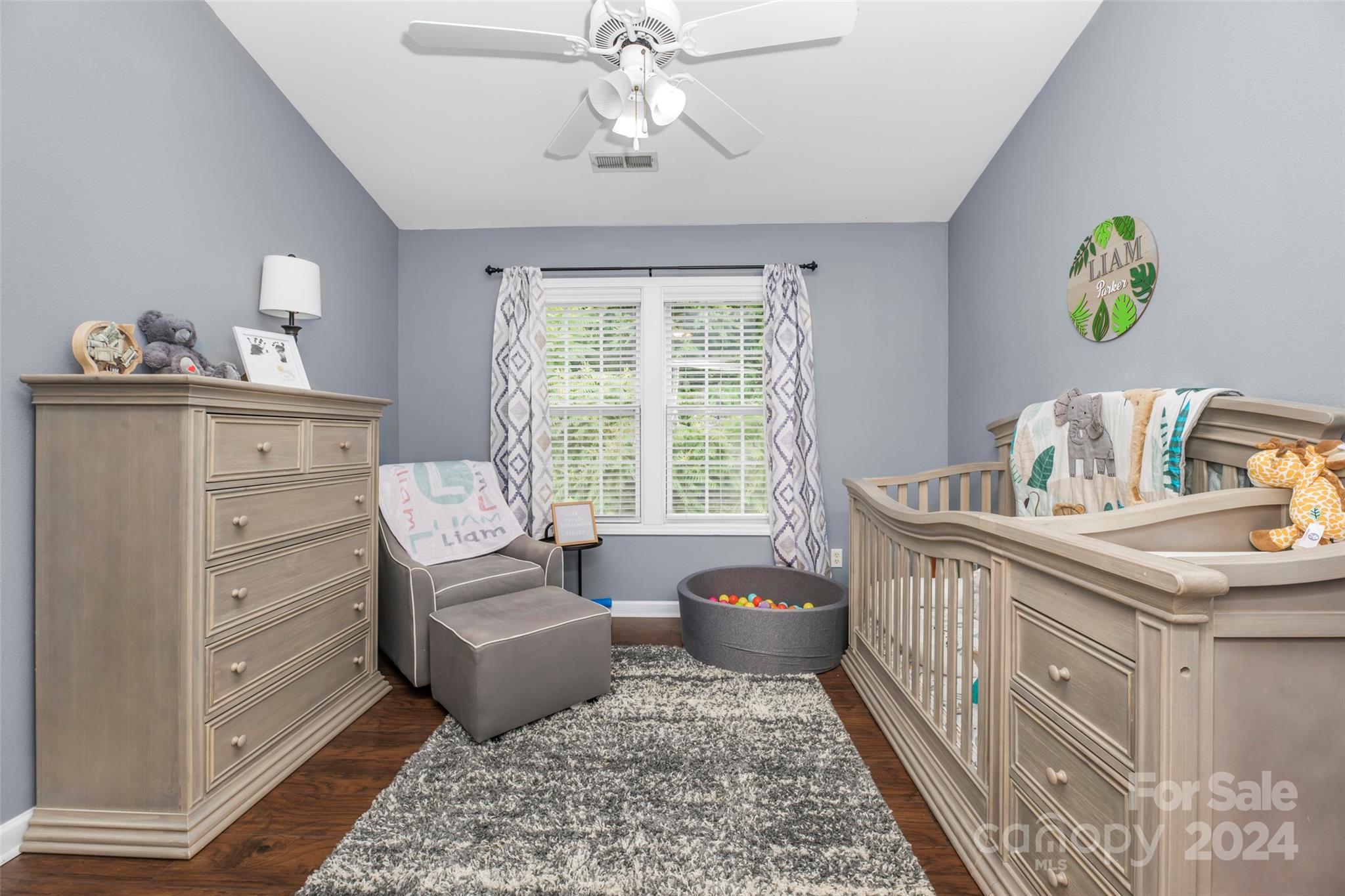 5810 Fox Ridge Lane Winston-Salem, NC 27104 - Photo 24 of 30 a bedroom with a bed and chandelier