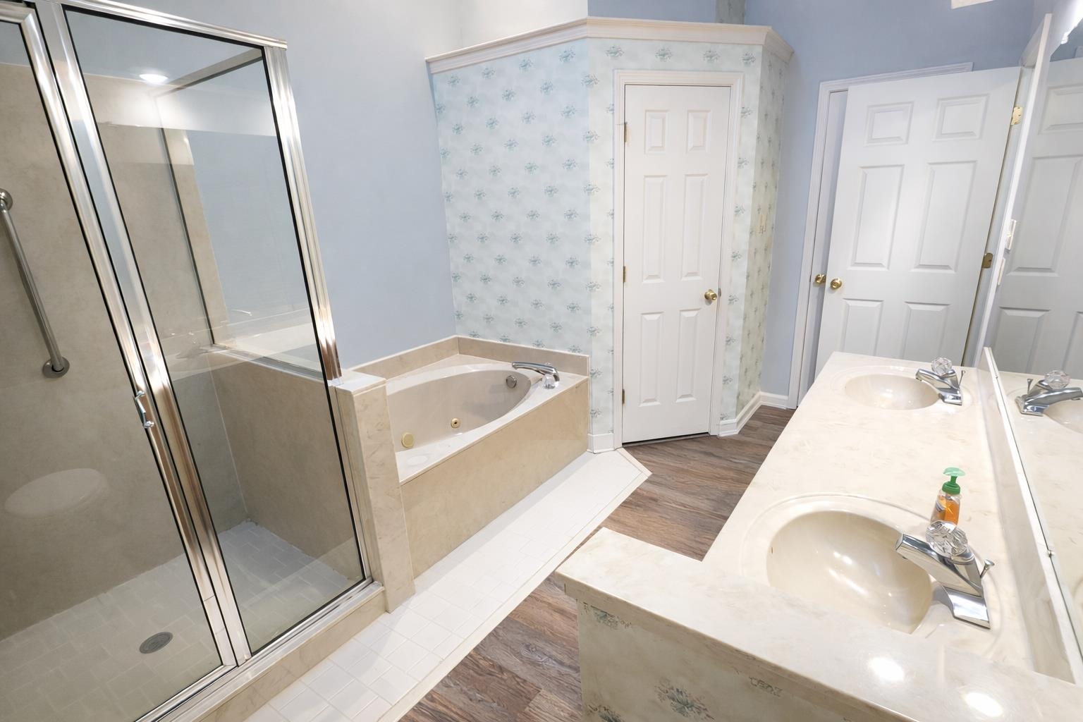 6708 Dawnhill Road Bartlett, TN 38135 - Photo 13 of 18 Spacious bathroom featuring a built-in jetted tub, a separate glass-enclosed shower with grab bar, and a dual vanity with integrated sinks