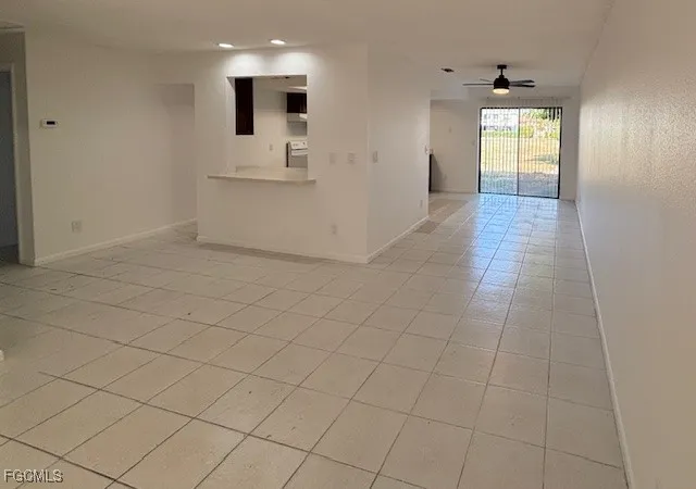 an empty room with cabinet and windows