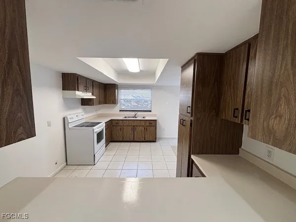 a kitchen with stainless steel appliances a refrigerator and a stove top oven
