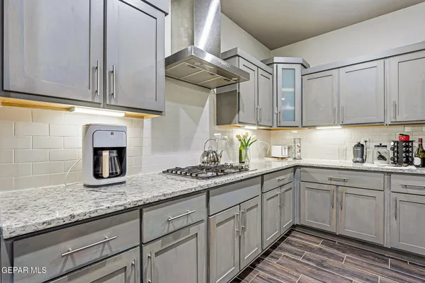 a kitchen with granite countertop stainless steel appliances a sink and cabinets