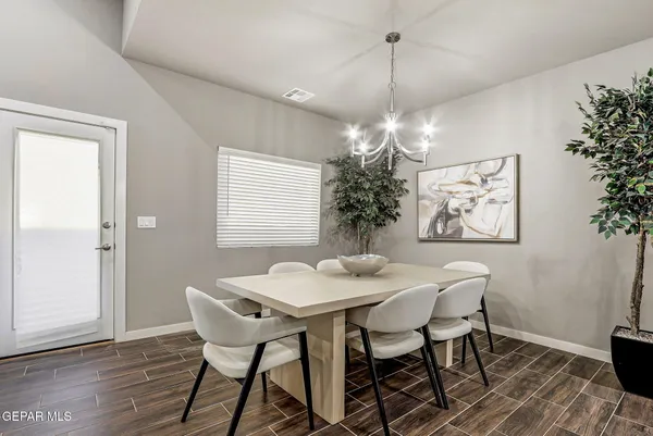 a view of a dining room with furniture and chandelier
