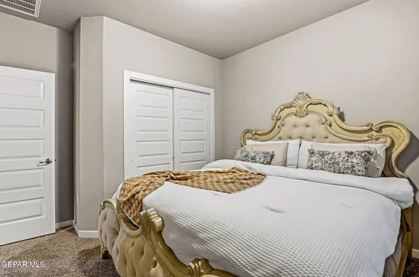 a bedroom with a bed and a closet