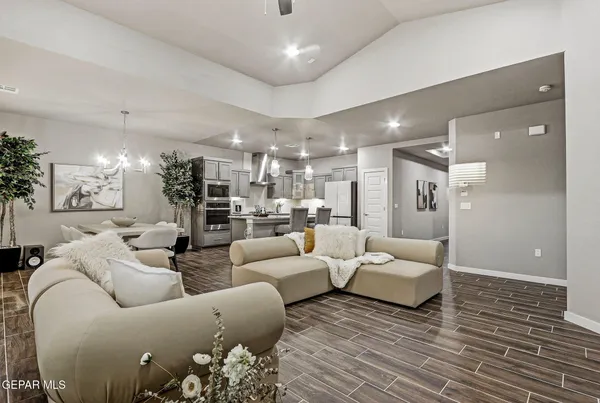 a living room with furniture and a view of kitchen