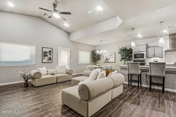 a living room with furniture and a wooden floor