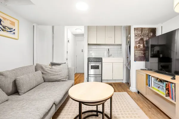 a living room with furniture a flat screen tv and a fireplace