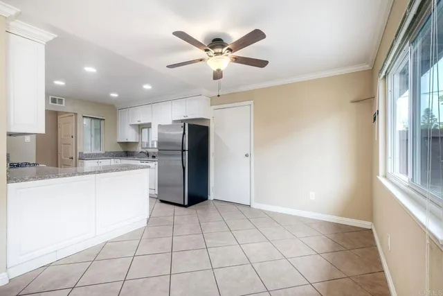 a kitchen with stainless steel appliances granite countertop a refrigerator and a sink