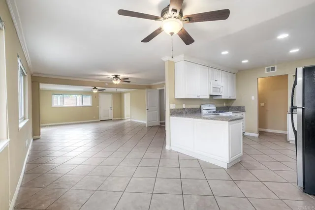 a view of a kitchen with cabinet and stainless steel appliances