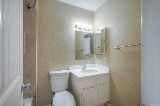 a bathroom with a sink mirror and toilet