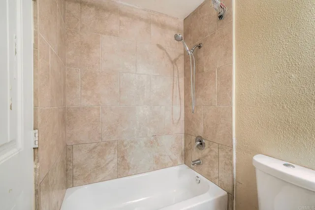a bathroom with a white bath tub and a shower