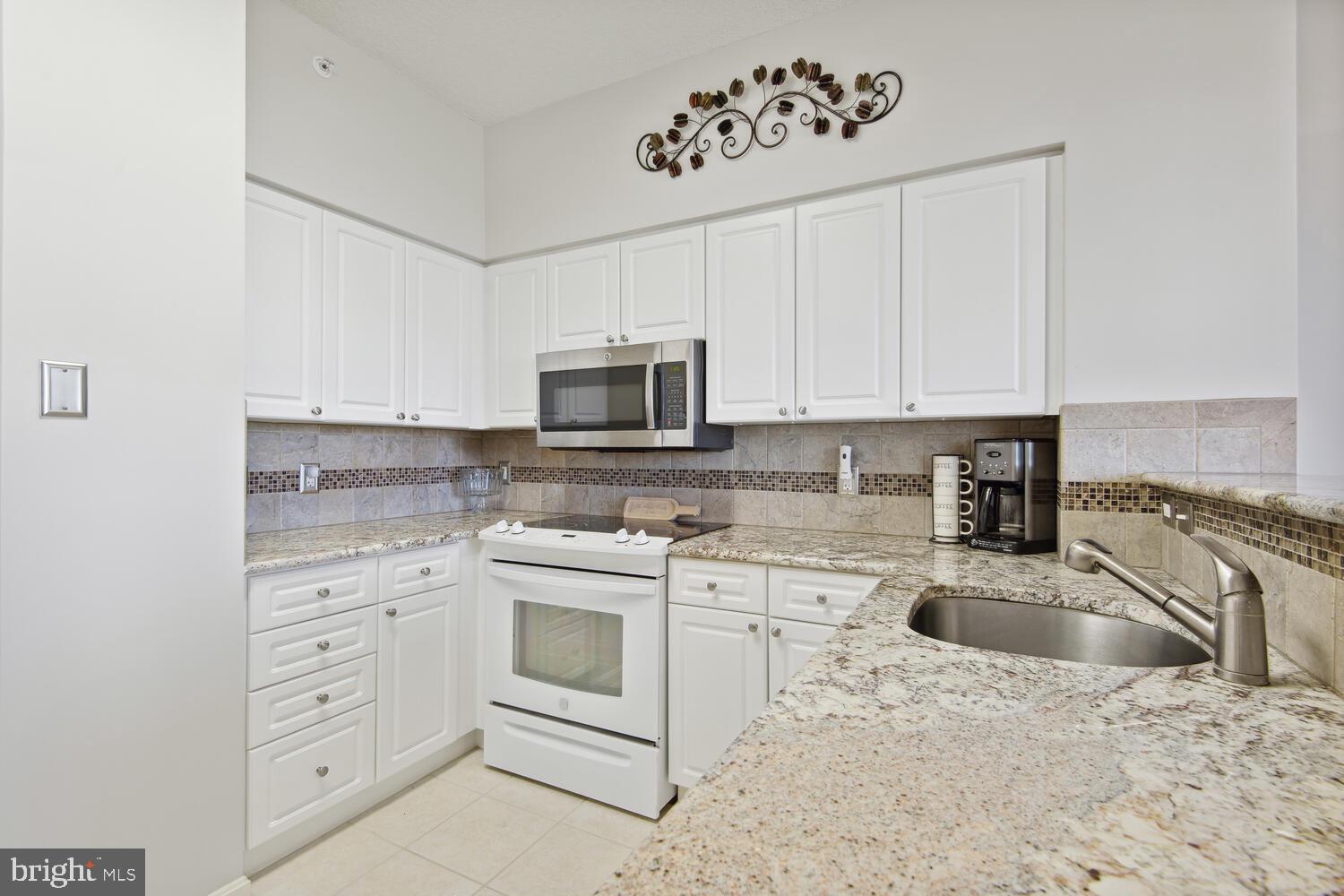 19375 Cypress Ridge Terrace, Unit 607 Leesburg, VA 20176 - Photo 14 of 30 Bright kitchen with abundant cabinets