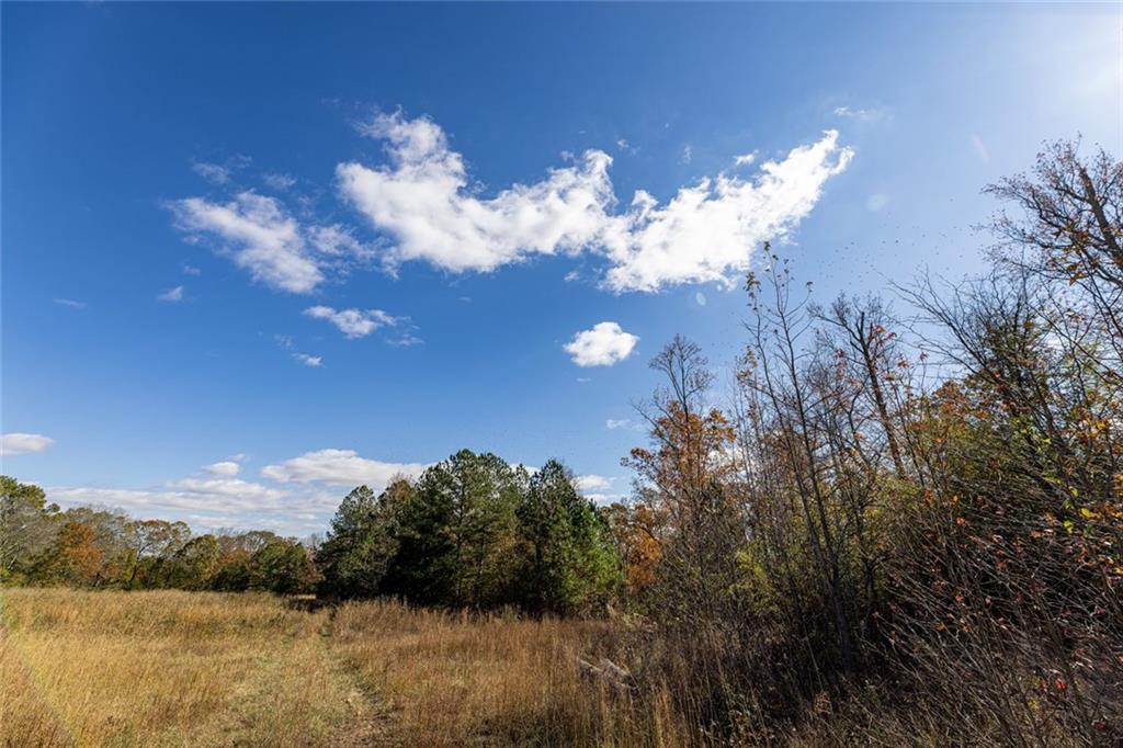 400 Kitchens Mountain Road Northwest Cartersville, GA 30120 - Photo 12 of 32 a sunset view with a lake