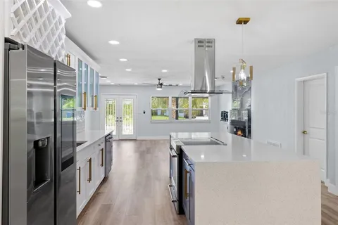 a kitchen with stainless steel appliances granite countertop a refrigerator and a sink