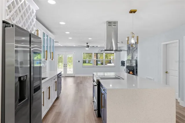 a kitchen with stainless steel appliances granite countertop a refrigerator and a sink