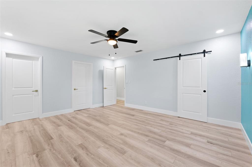 8231 31st Terrace North St. Petersburg, FL 33710 - Photo 25 of 55 a view of empty room with wooden floor and ceiling fan