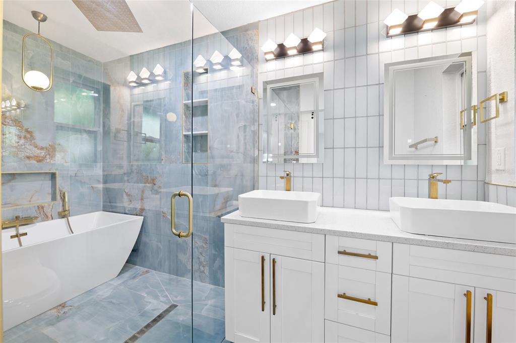 8231 31st Terrace North St. Petersburg, FL 33710 - Photo 26 of 55 a bathroom with a tub sink and mirror