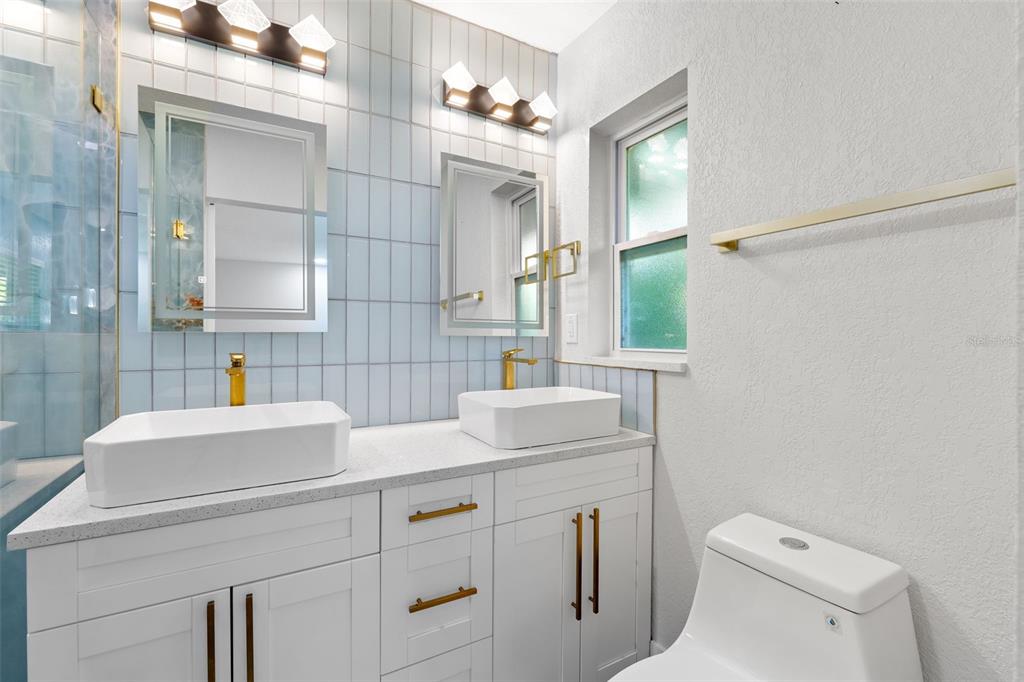 8231 31st Terrace North St. Petersburg, FL 33710 - Photo 27 of 55 a bathroom with a sink toilet vanity and mirror