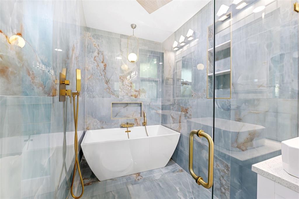 8231 31st Terrace North St. Petersburg, FL 33710 - Photo 28 of 55 a bathroom with a bathtub and a shower