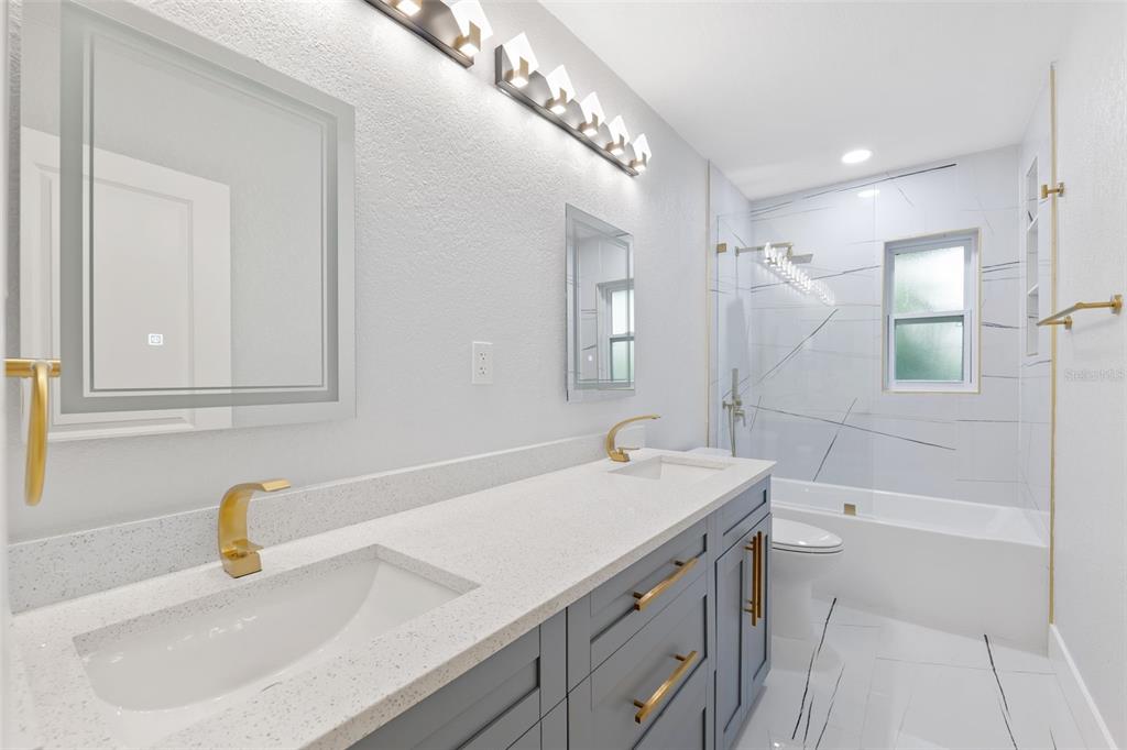 8231 31st Terrace North St. Petersburg, FL 33710 - Photo 33 of 55 a bathroom with a sink and a mirror