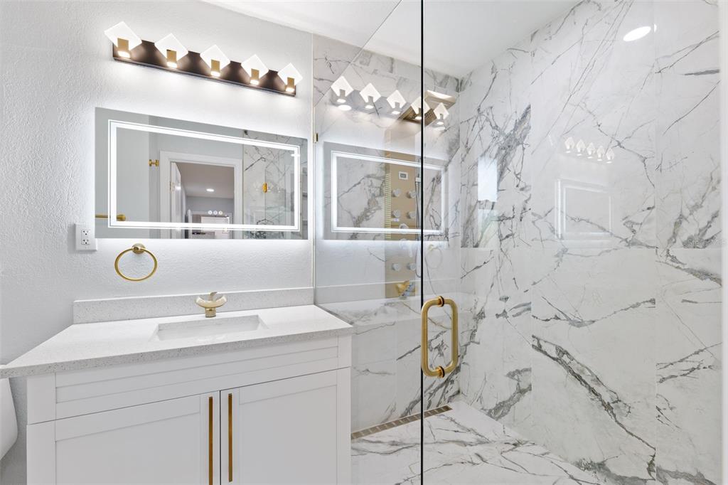 8231 31st Terrace North St. Petersburg, FL 33710 - Photo 38 of 55 a bathroom with a sink mirror and vanity