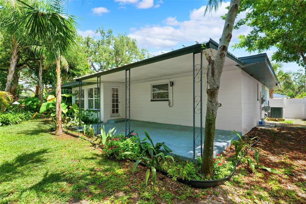 8231 31st Terrace North St. Petersburg, FL 33710 - Photo 46 of 55 a backyard of a house with plants and large tree