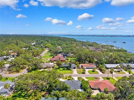 an aerial view of a house with a garden and trees