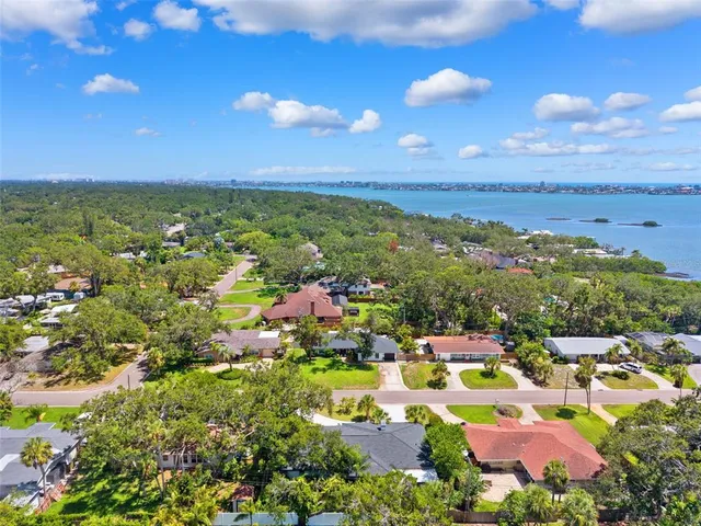an aerial view of a house with a garden and trees