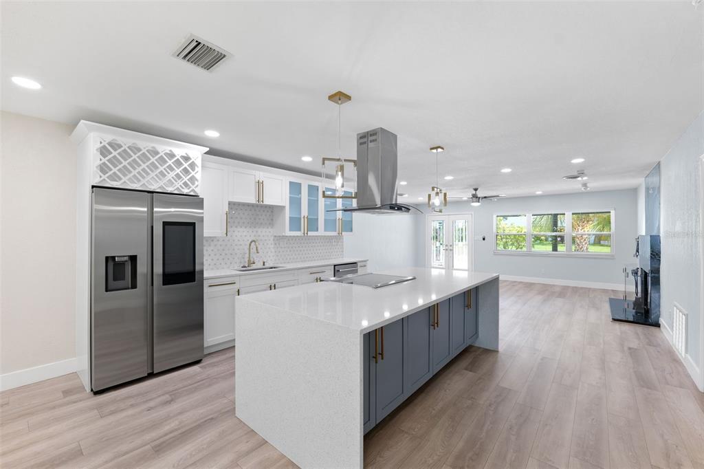 8231 31st Terrace North St. Petersburg, FL 33710 - Photo 6 of 55 a kitchen with stainless steel appliances granite countertop a kitchen island a hardwood floor and a sink