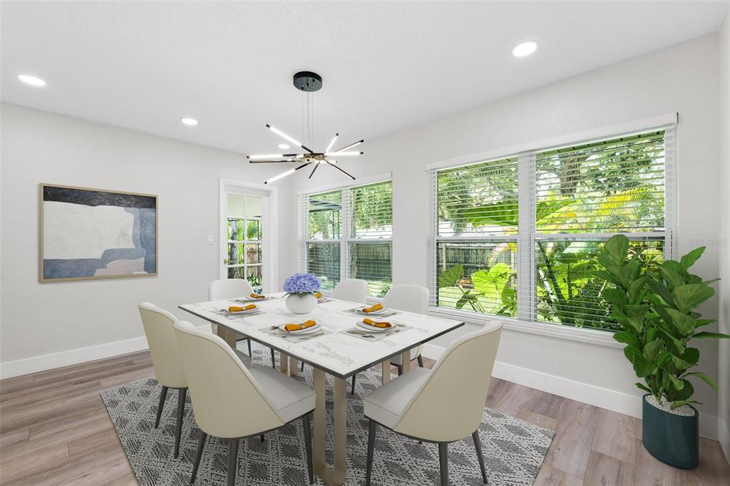 8231 31st Terrace North St. Petersburg, FL 33710 - Photo 10 of 55 a view of a dining room with furniture large windows and wooden floor