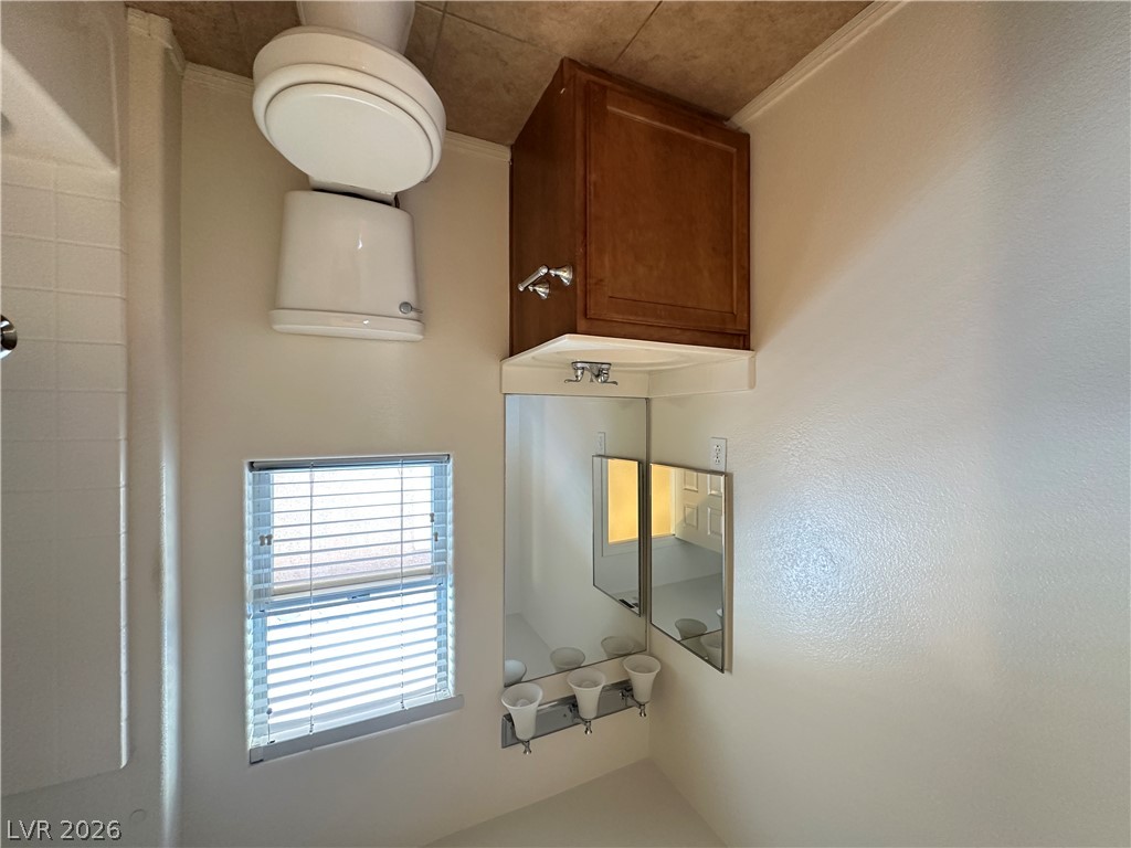 7305 Prussian Green Street Las Vegas, NV 89139 - Photo 13 of 23 Functional full bathroom with a compact vanity and mirrored cabinet, perfect for daily routines.