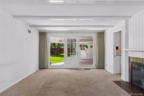 a view of an empty room and a fireplace