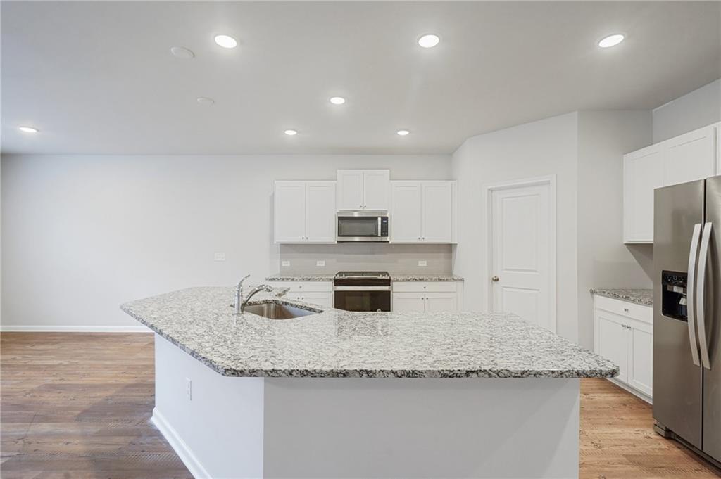 2101 Ecoland Drive Grayson, GA 30017 - Photo 8 of 26 a kitchen with granite countertop stainless steel appliances and a counter space