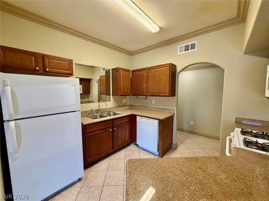 5525 West Flamingo Road, Unit 1019 Las Vegas, NV 89103 - Photo 5 of 18 A functional kitchen with warm wood cabinetry and durable tile flooring awaits culinary creations.