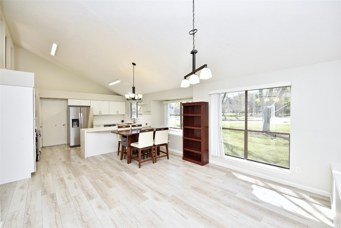 3203 East Rangecrest Place Sugar Land, TX 77479 - Photo 12 of 36 a view of a kitchen with dining area wooden floor and appliances