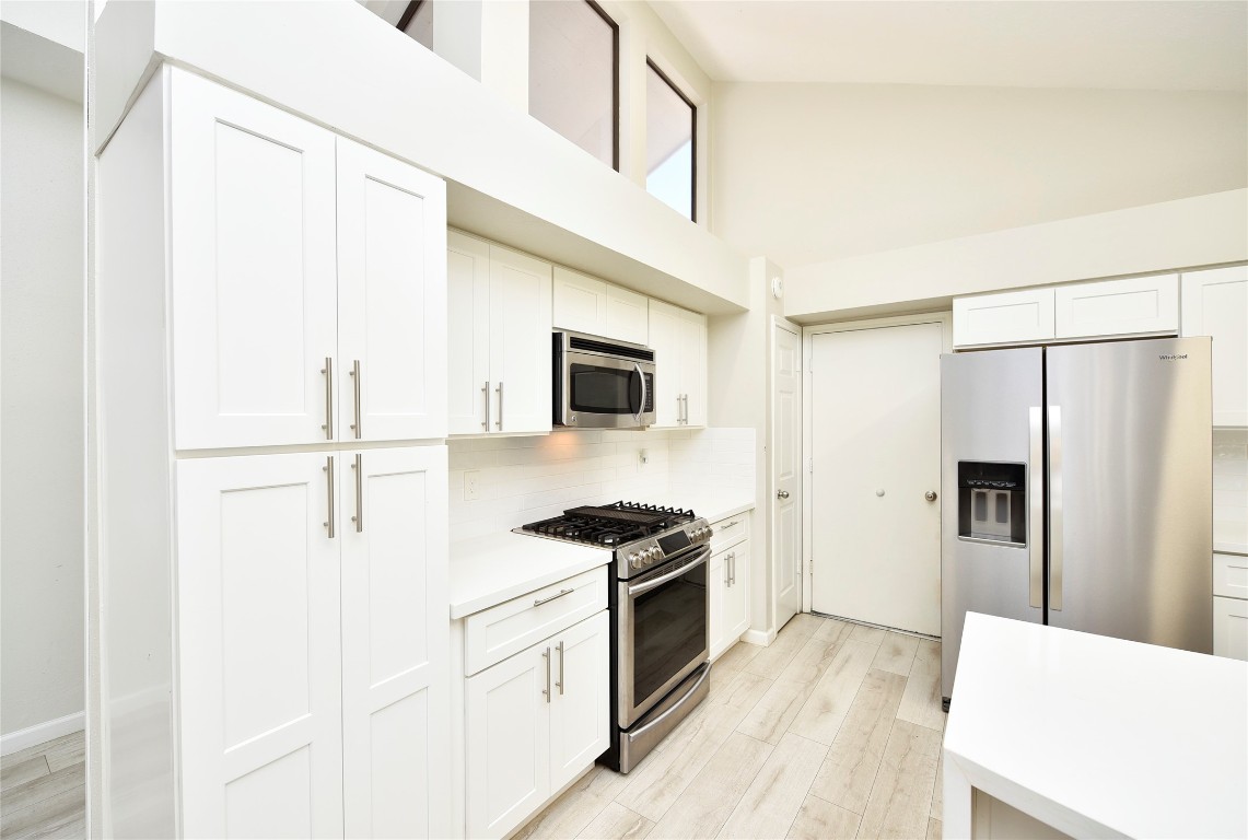 3203 East Rangecrest Place Sugar Land, TX 77479 - Photo 15 of 36 a kitchen with stainless steel appliances a refrigerator stove and microwave