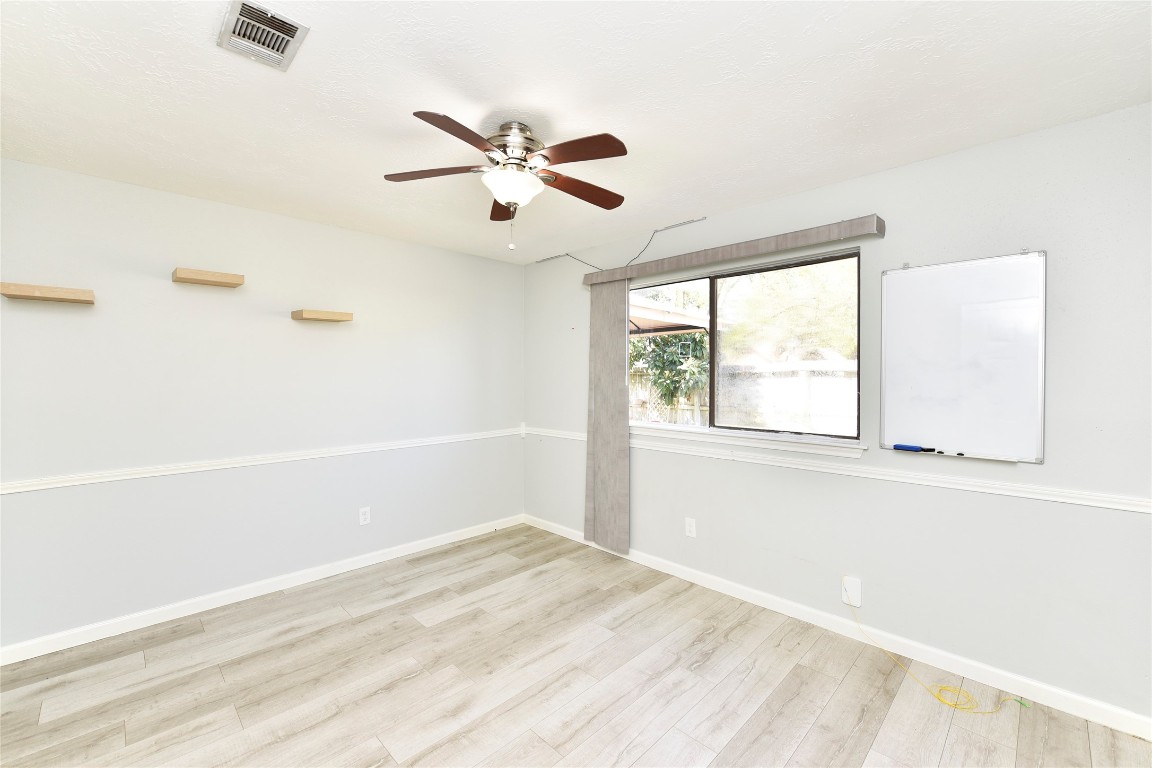 3203 East Rangecrest Place Sugar Land, TX 77479 - Photo 17 of 36 a view of empty room with window and wooden floor