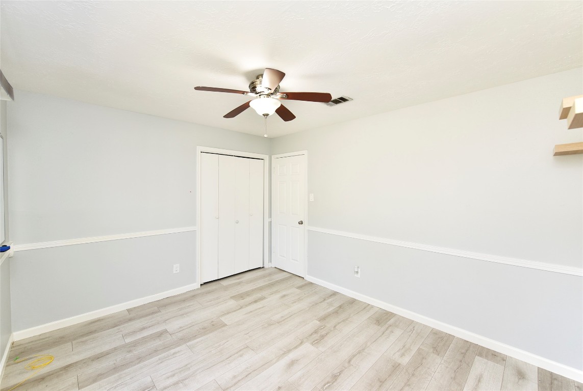 3203 East Rangecrest Place Sugar Land, TX 77479 - Photo 18 of 36 a view of a room with a white walls and a ceiling fan