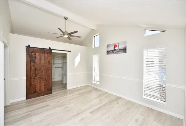 a view of a livingroom with a window and a ceiling fan