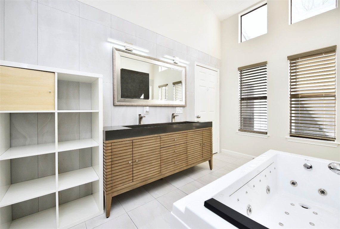 3203 East Rangecrest Place Sugar Land, TX 77479 - Photo 29 of 36 a bathroom with a tub sink and mirror