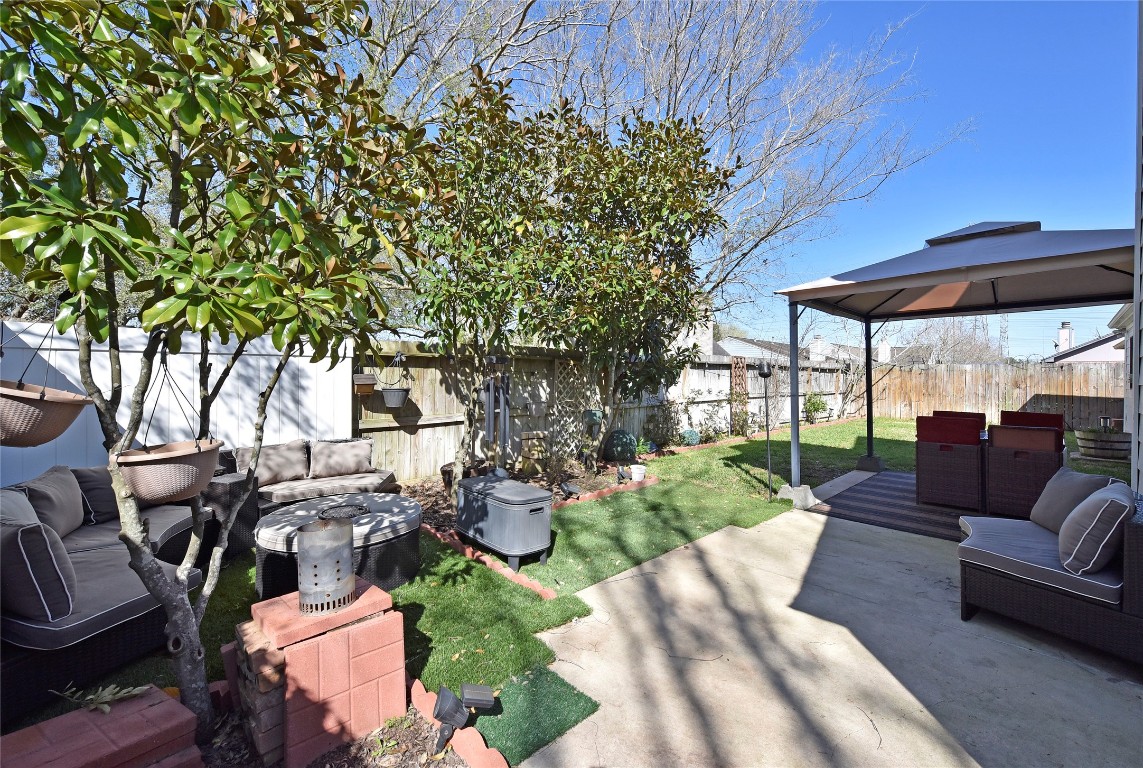 3203 East Rangecrest Place Sugar Land, TX 77479 - Photo 33 of 36 a view of a backyard with couches plants and large trees