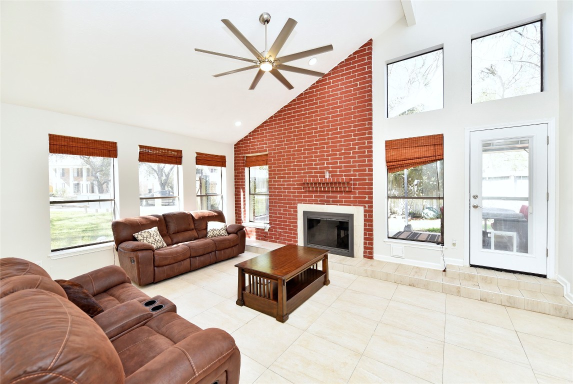 3203 East Rangecrest Place Sugar Land, TX 77479 - Photo 7 of 36 a living room with furniture a large window and a fireplace